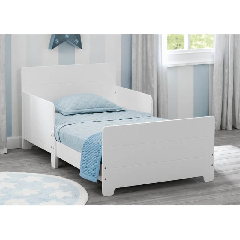 Wooden toddler bed with two saftey rails.